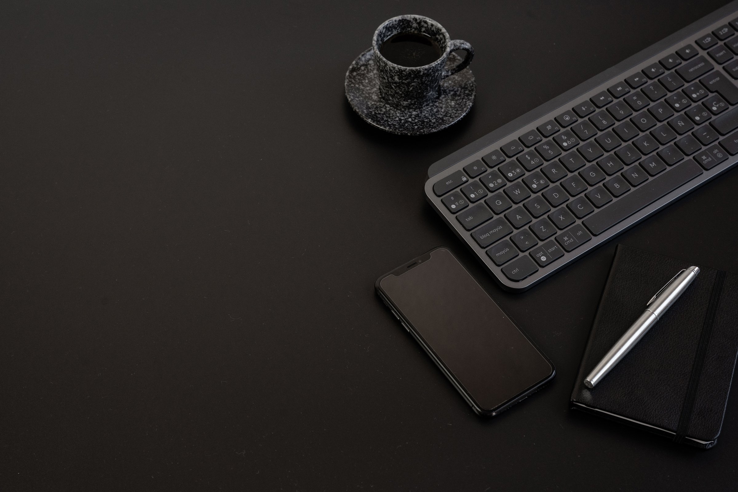 Phone, Computer Accessories and Coffee on Black Background